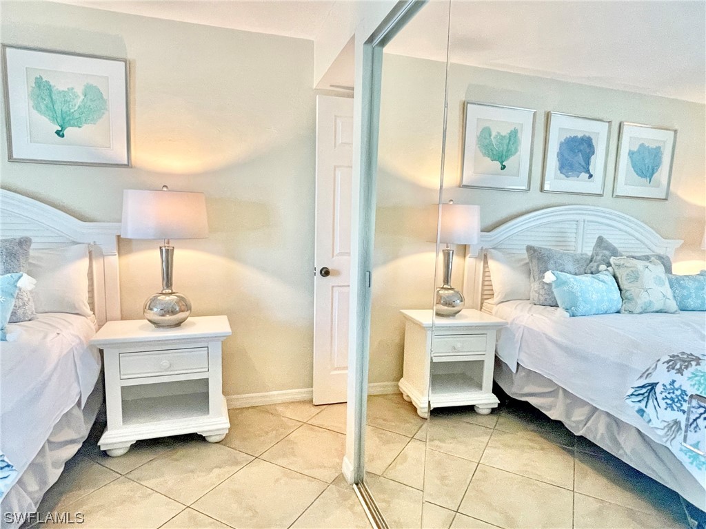 2521 Beach Villas Captiva, FL 33924 - Photo 26 of 50 a bedroom with a bed and a table