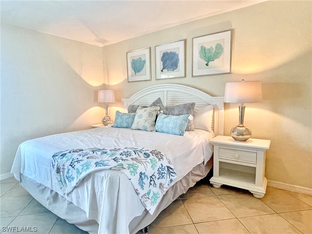 2521 Beach Villas Captiva, FL 33924 - Photo 27 of 50 a bedroom with a bed and window