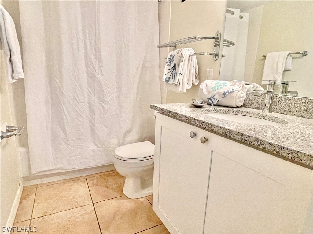 2521 Beach Villas Captiva, FL 33924 - Photo 29 of 50 a bathroom with a granite countertop sink a toilet and a shower