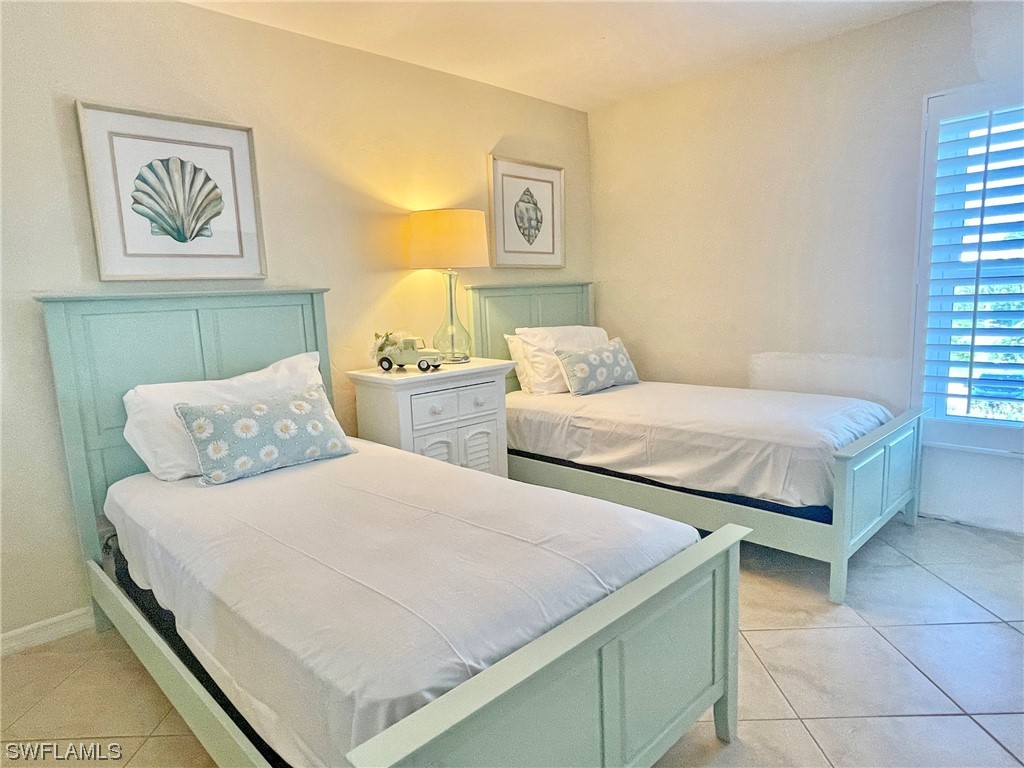 2521 Beach Villas Captiva, FL 33924 - Photo 30 of 50 a bedroom with two beds and painting on the wall