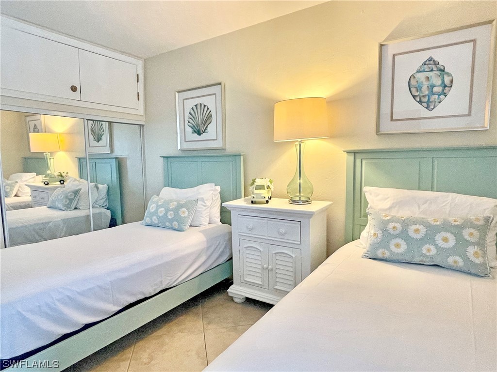 2521 Beach Villas Captiva, FL 33924 - Photo 32 of 50 a bedroom with two beds and painting on the wall