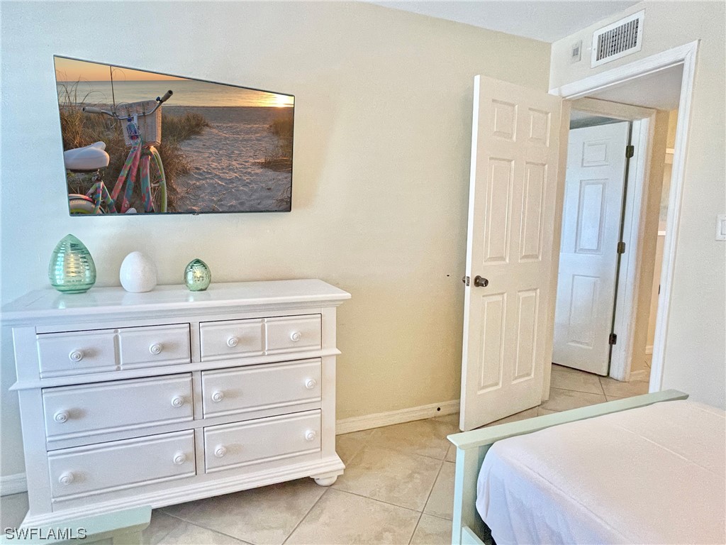 2521 Beach Villas Captiva, FL 33924 - Photo 33 of 50 a bedroom with a bed and a cabinets