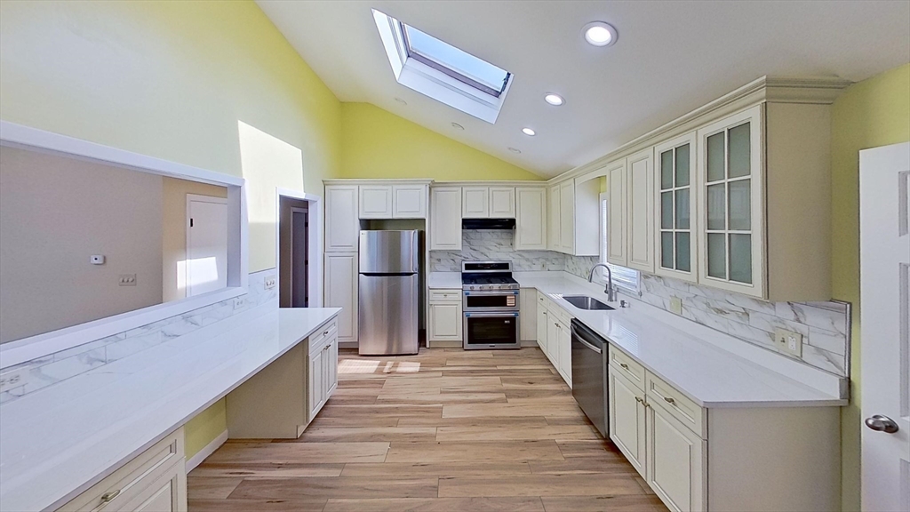 52 Rockefeller Street, Unit 2 Randolph, MA 02368 - Photo 1 of 9 a large kitchen with stainless steel appliances kitchen island granite countertop a large counter top stainless steel appliances and cabinets