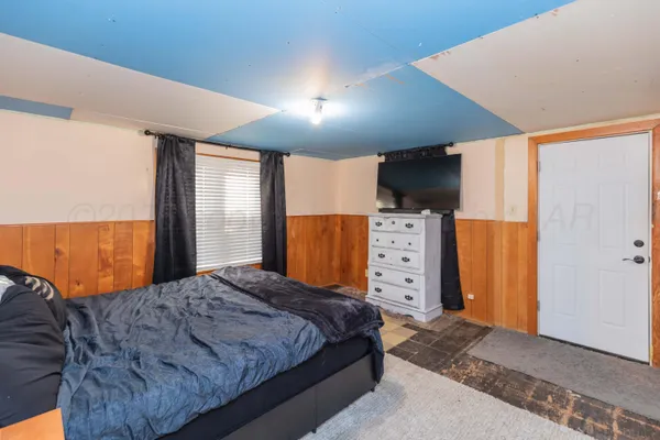 a bedroom with a bed and a walk in closet