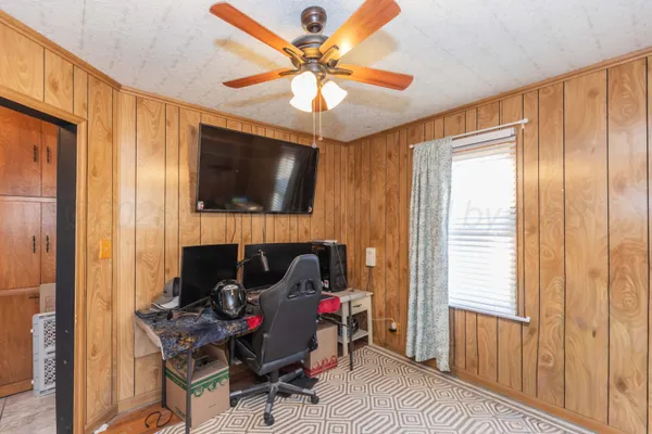 a living room with furniture a flat screen tv and a window