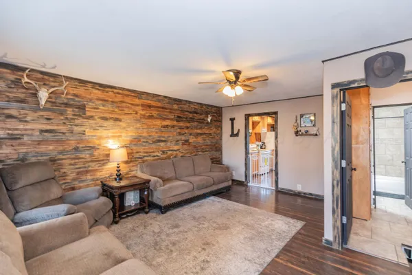 a living room with furniture and wooden floor