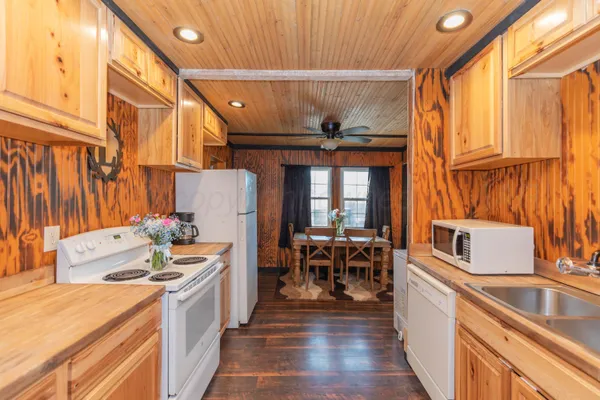 a kitchen with stainless steel appliances a stove a sink and a refrigerator