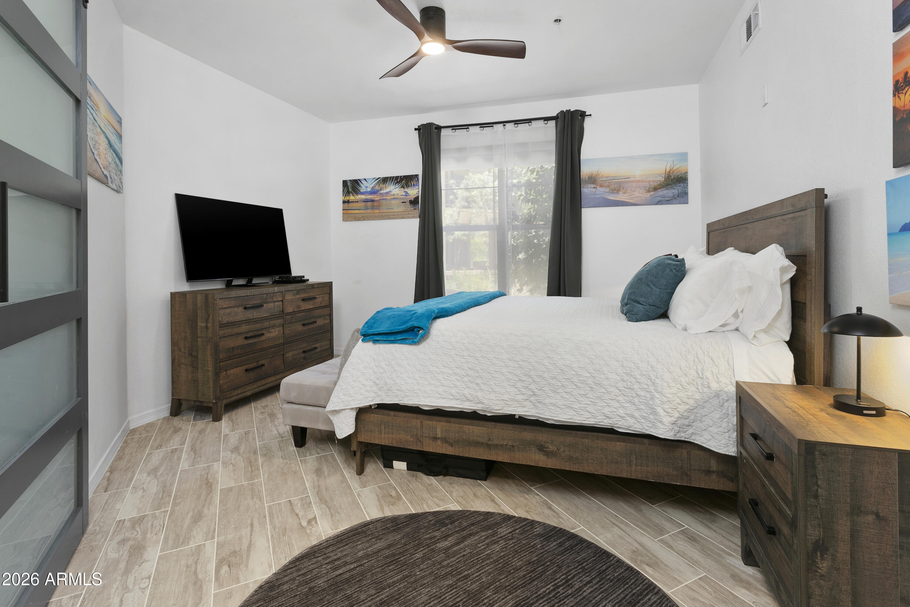 7601 East Indian Bend Road, Unit 1017 Scottsdale, AZ 85250 - Photo 14 of 49 a bedroom with a bed and flat screen tv