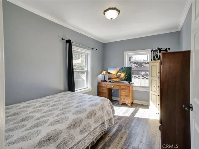 a bedroom with a bed dresser and mirror