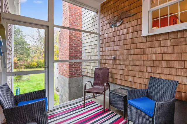 a dining room with furniture a chandelier and wooden floor