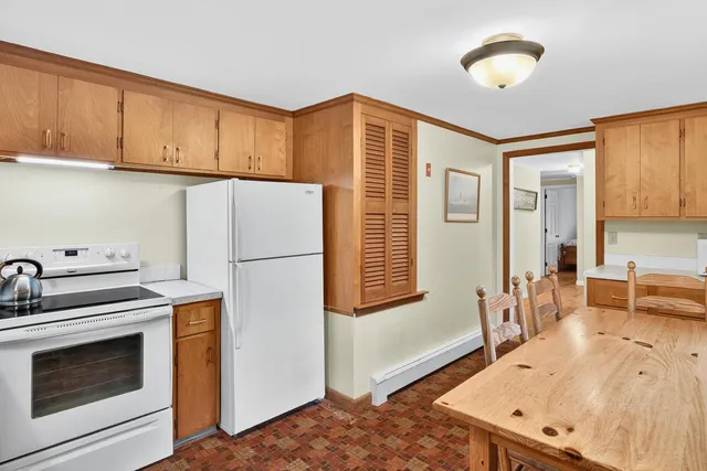 a bathroom with a sink mirror and a toilet