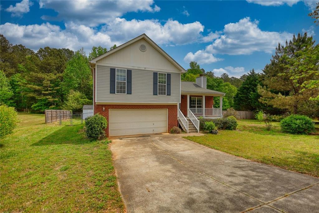 1916 Brenda Street Statham, GA 30666 - Photo 1 of 21 a front view of a house with a yard and garage