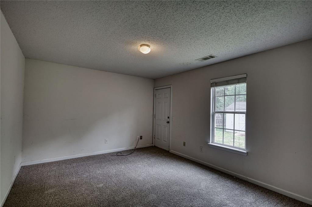 1916 Brenda Street Statham, GA 30666 - Photo 11 of 21 a view of an empty room with a window