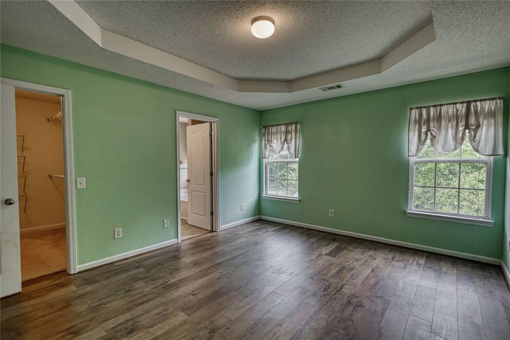 1916 Brenda Street Statham, GA 30666 - Photo 13 of 21 an empty room with wooden floor closet and windows