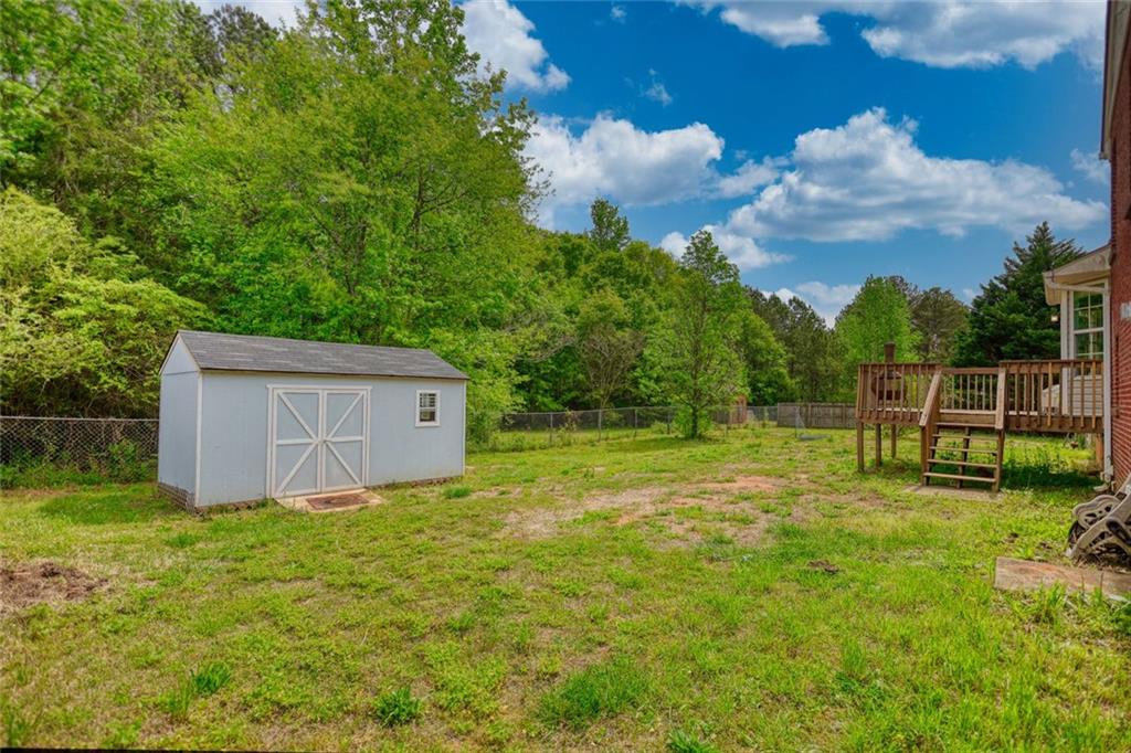 1916 Brenda Street Statham, GA 30666 - Photo 21 of 21 a view of a backyard with grass and a palm tree