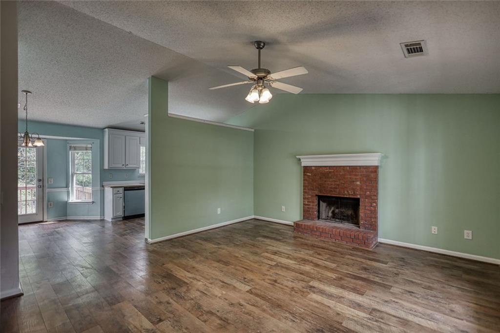 1916 Brenda Street Statham, GA 30666 - Photo 5 of 21 wooden floor fireplace and windows in an empty room