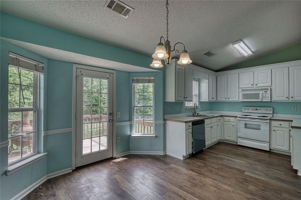 1916 Brenda Street Statham, GA 30666 - Photo 8 of 21 a large kitchen with stainless steel appliances granite countertop a stove and a wooden floors
