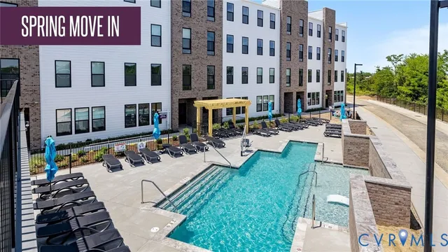 a living room with furniture a flat screen tv and a large window