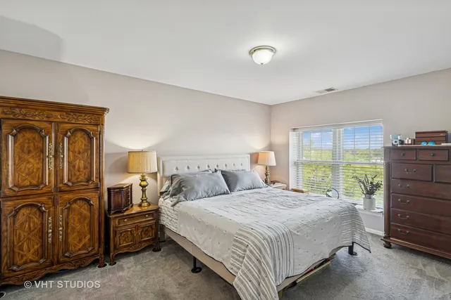 a bedroom with a bed next to a window