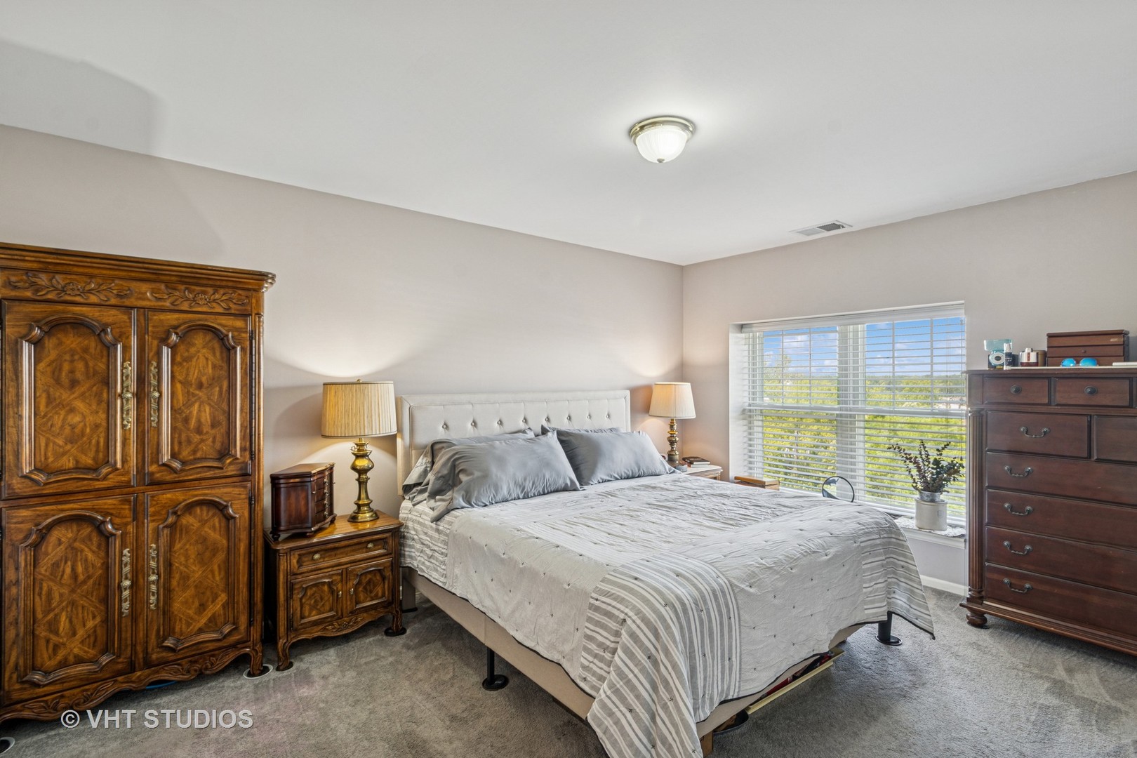 390 West Mahogany Court, Unit 606 Palatine, IL 60067 - Photo 12 of 27 a bedroom with a bed next to a window