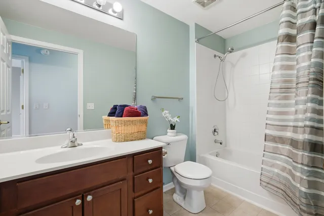 a bathroom with a sink toilet vanity and shower