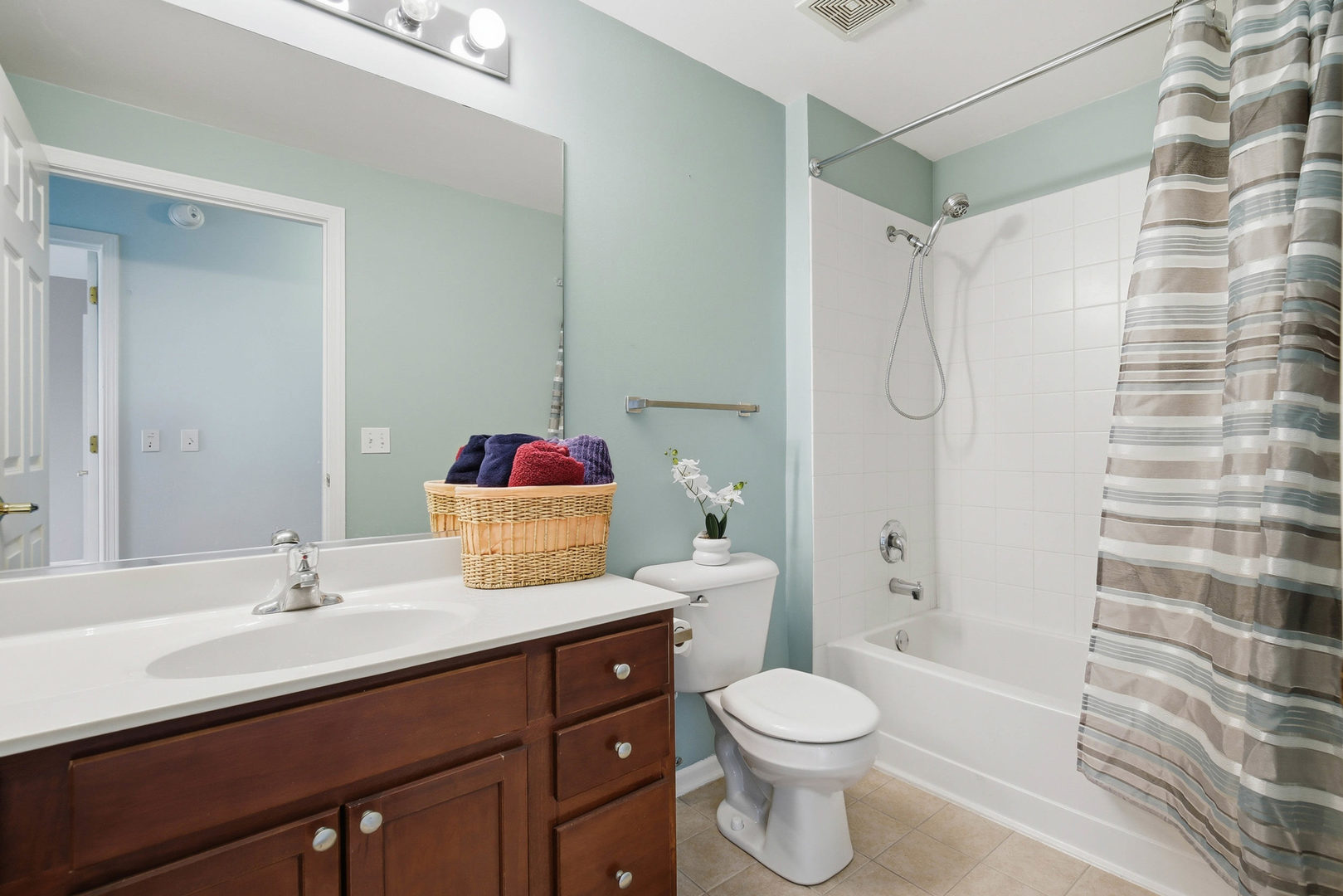 390 West Mahogany Court, Unit 606 Palatine, IL 60067 - Photo 17 of 27 a bathroom with a sink toilet vanity and shower