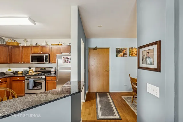 a kitchen with stainless steel appliances granite countertop a refrigerator and a stove
