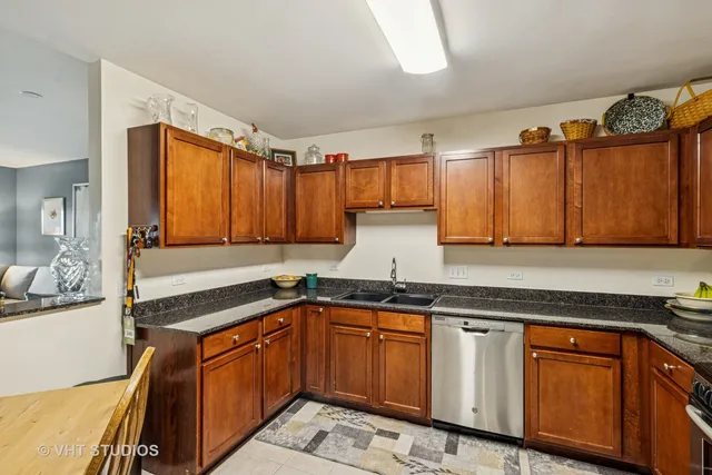 a kitchen with granite countertop a sink and cabinets