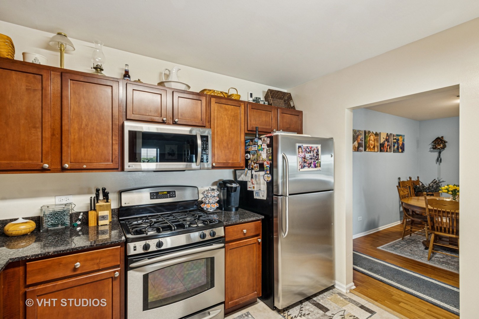 390 West Mahogany Court, Unit 606 Palatine, IL 60067 - Photo 8 of 27 a kitchen with stainless steel appliances granite countertop a refrigerator stove and sink