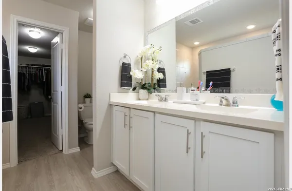 a bathroom with a double vanity sink mirror and