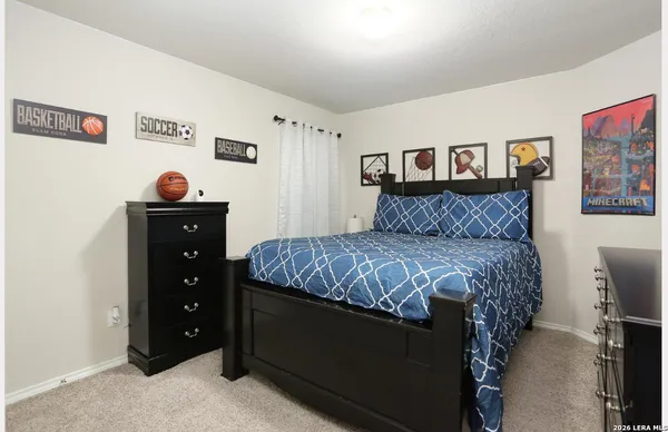 a bedroom with a bed and a dresser