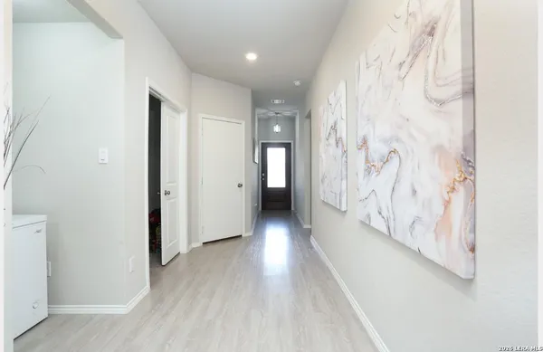 a view of a hallway with wooden floor