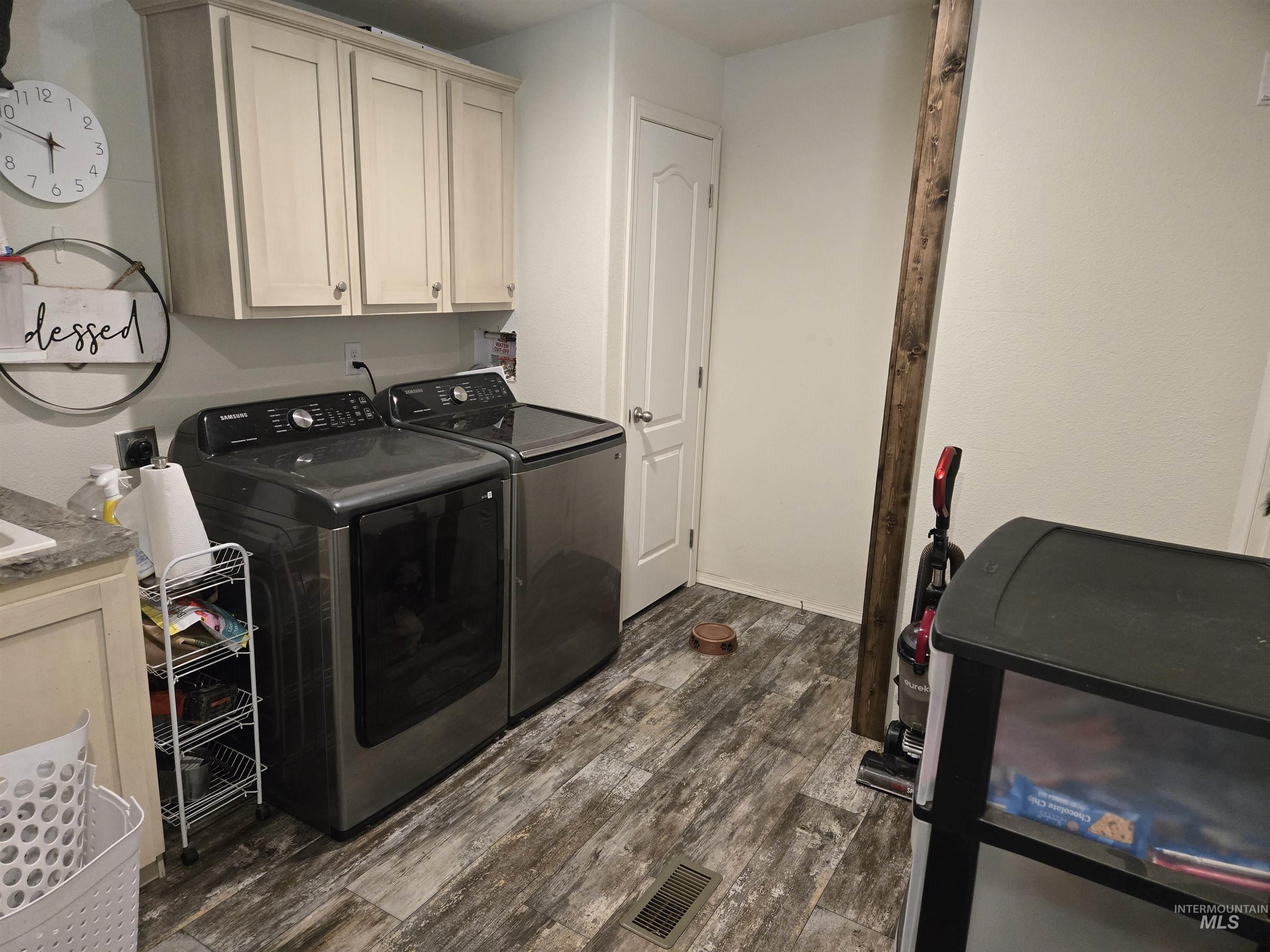 174 Konkolville Road Orofino, ID 83544 - Photo 29 of 43 Laundry area featuring wood-finish flooring and light-toned upper cabinetry