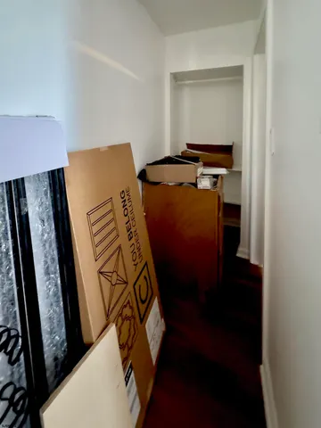 a view of walk in closet with clothes