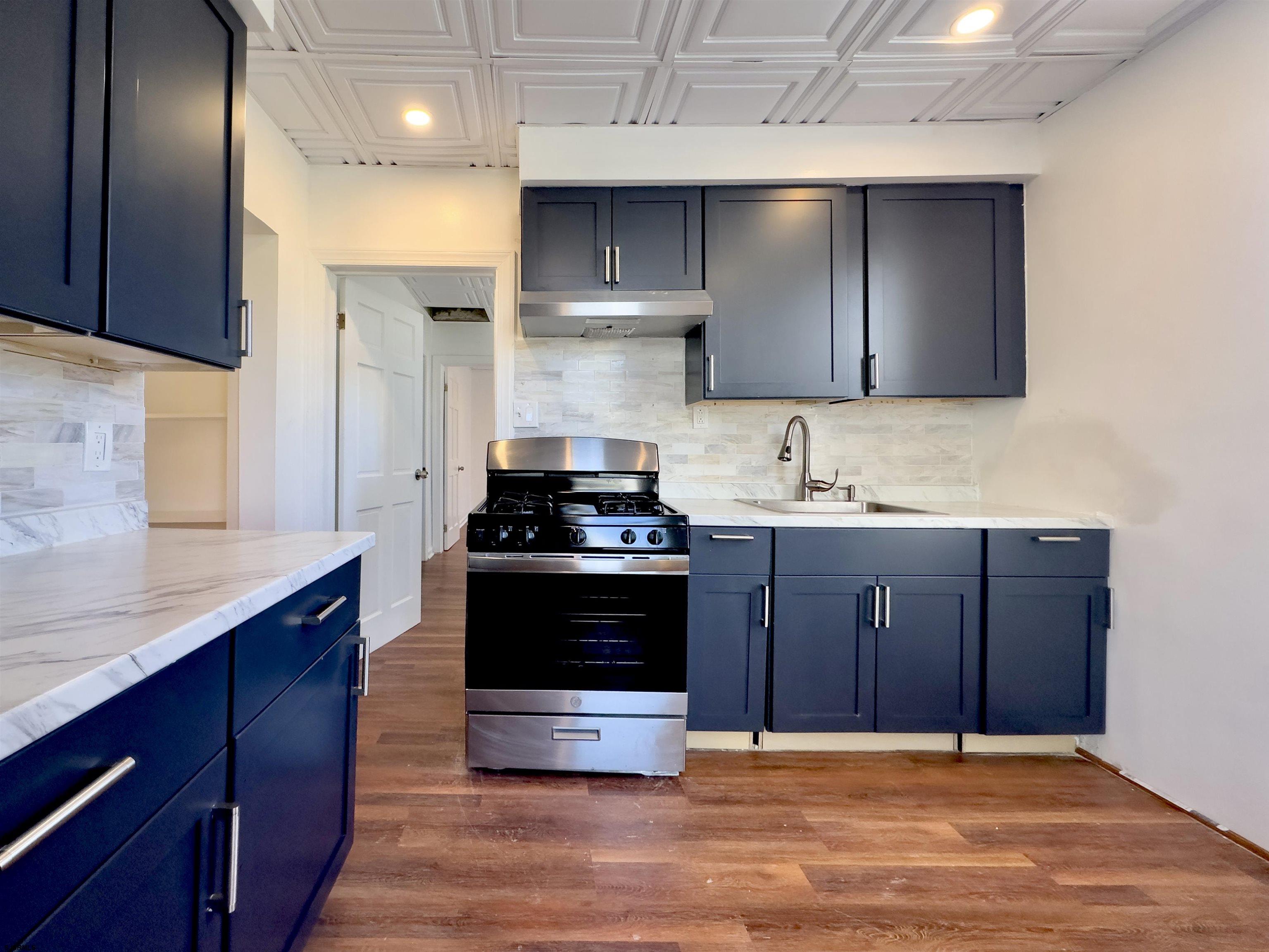 101 New Jersey Avenue, Unit A Atlantic City, NJ 08401 - Photo 6 of 13 a kitchen with stainless steel appliances granite countertop a stove a sink and a refrigerator