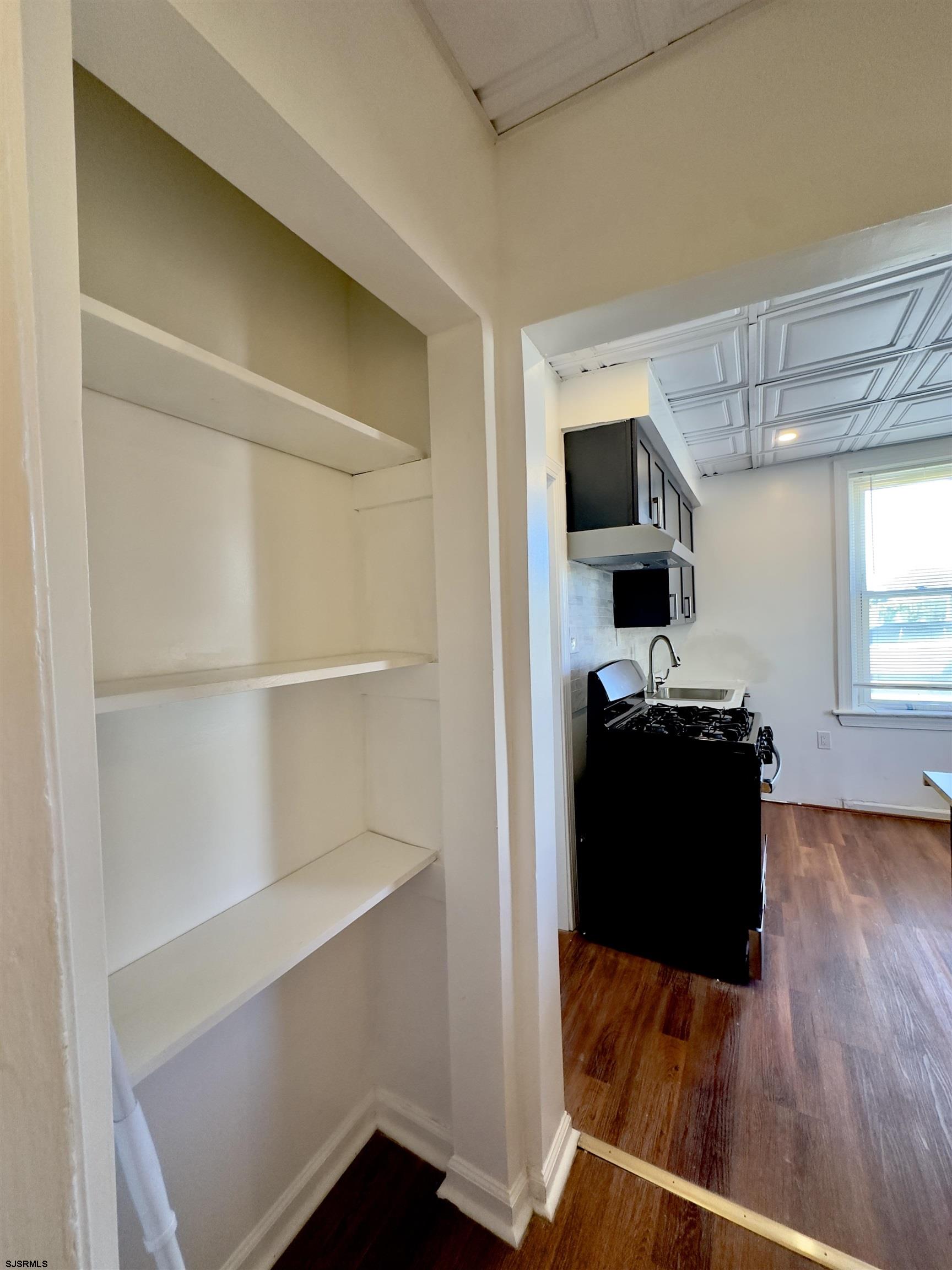 101 New Jersey Avenue, Unit A Atlantic City, NJ 08401 - Photo 10 of 13 a view of a living room with wooden floor and a window