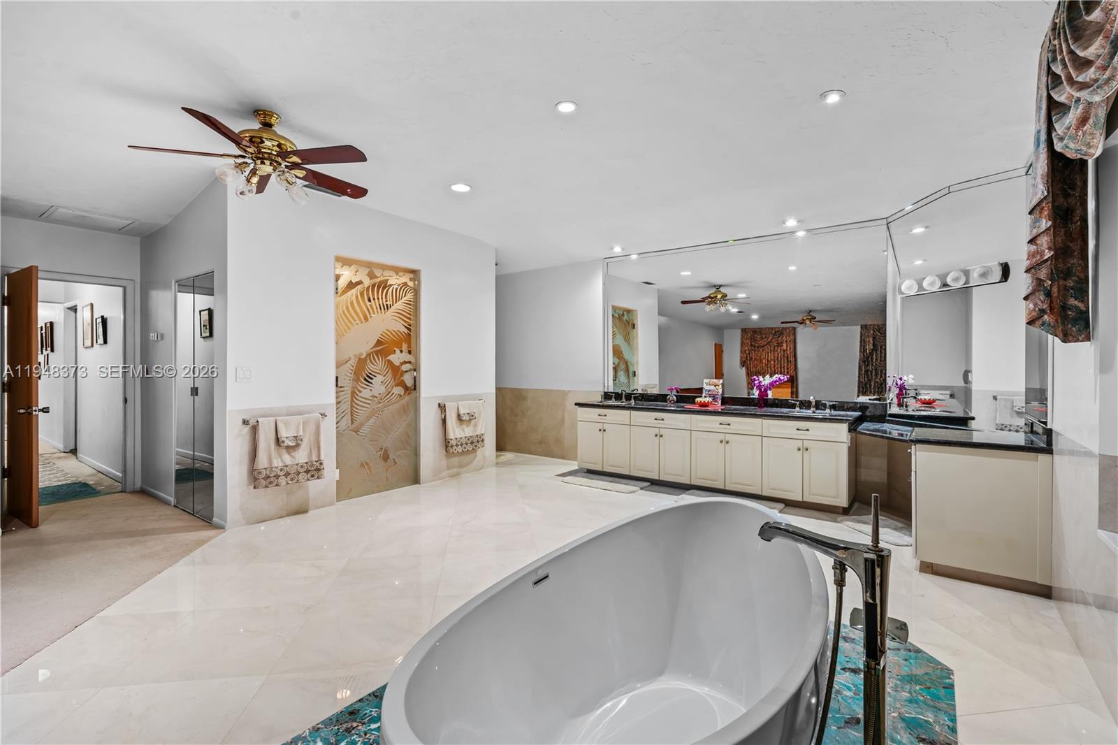 18455 Southwest 284th Street Homestead, FL 33030 - Photo 11 of 15 a kitchen with stainless steel appliances kitchen island a refrigerator sink and white cabinets