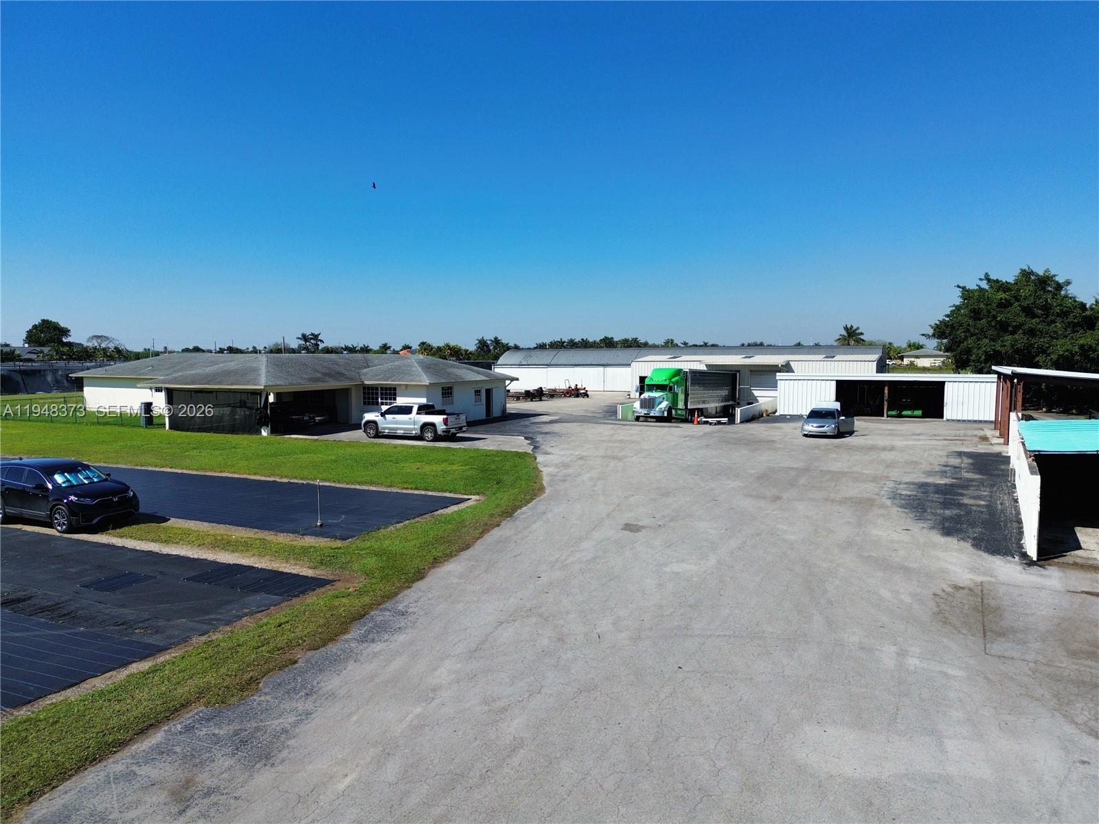 18455 Southwest 284th Street Homestead, FL 33030 - Photo 4 of 15 a view of a terrace with a bench