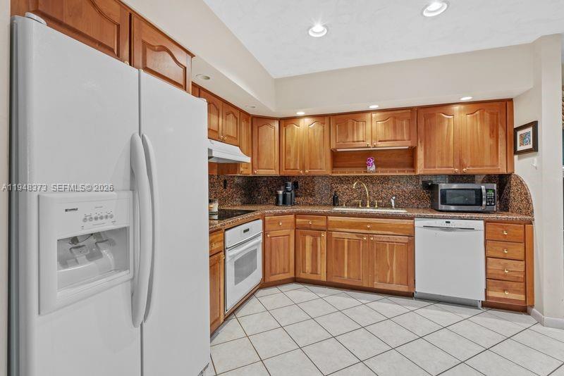 18455 Southwest 284th Street Homestead, FL 33030 - Photo 9 of 15 a kitchen with stainless steel appliances granite countertop a refrigerator and a stove top oven