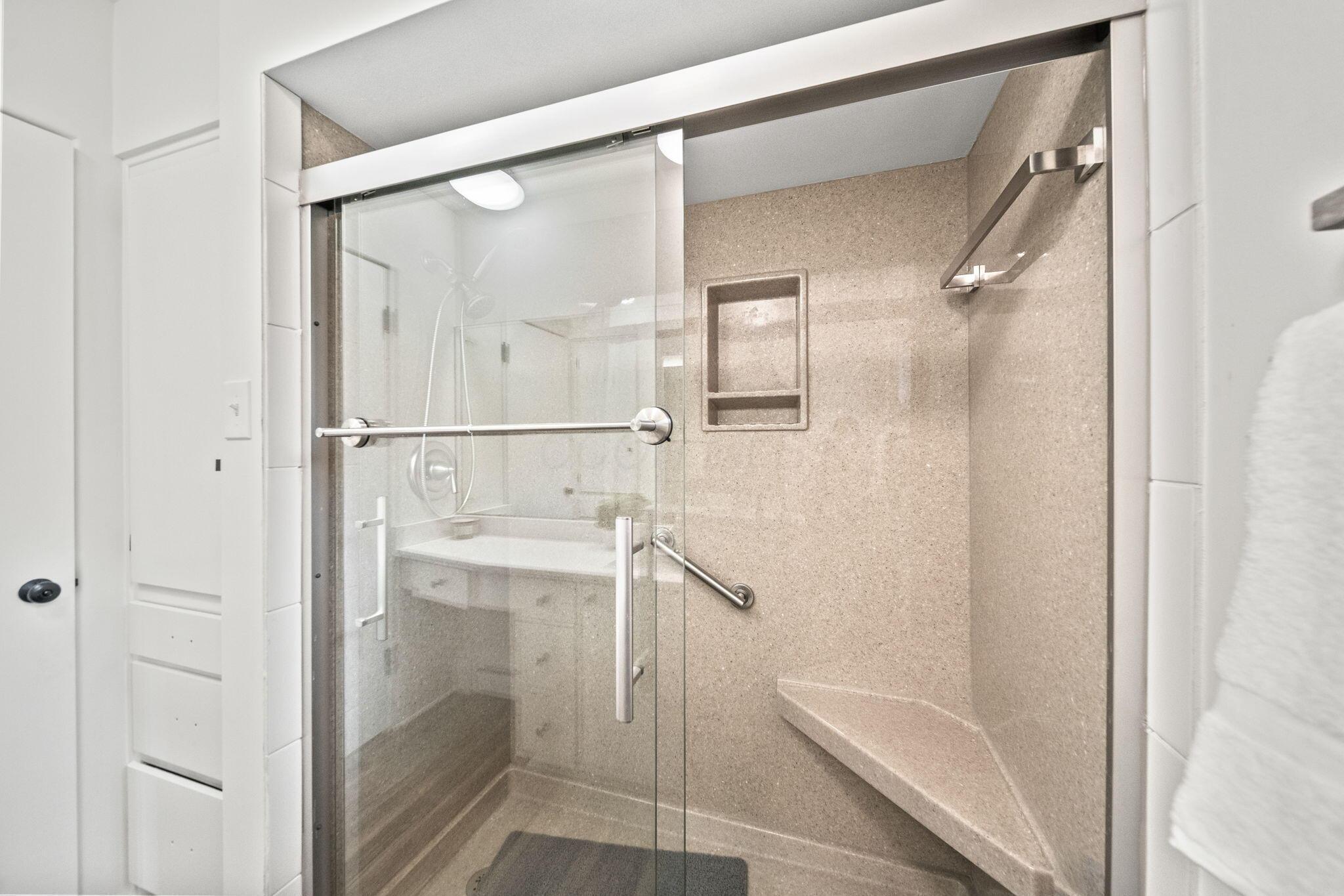 3496 Wicklow Road Columbus, OH 43204 - Photo 25 of 53 Glass-enclosed shower with a built-in bench, integrated wall niche, and grab bar