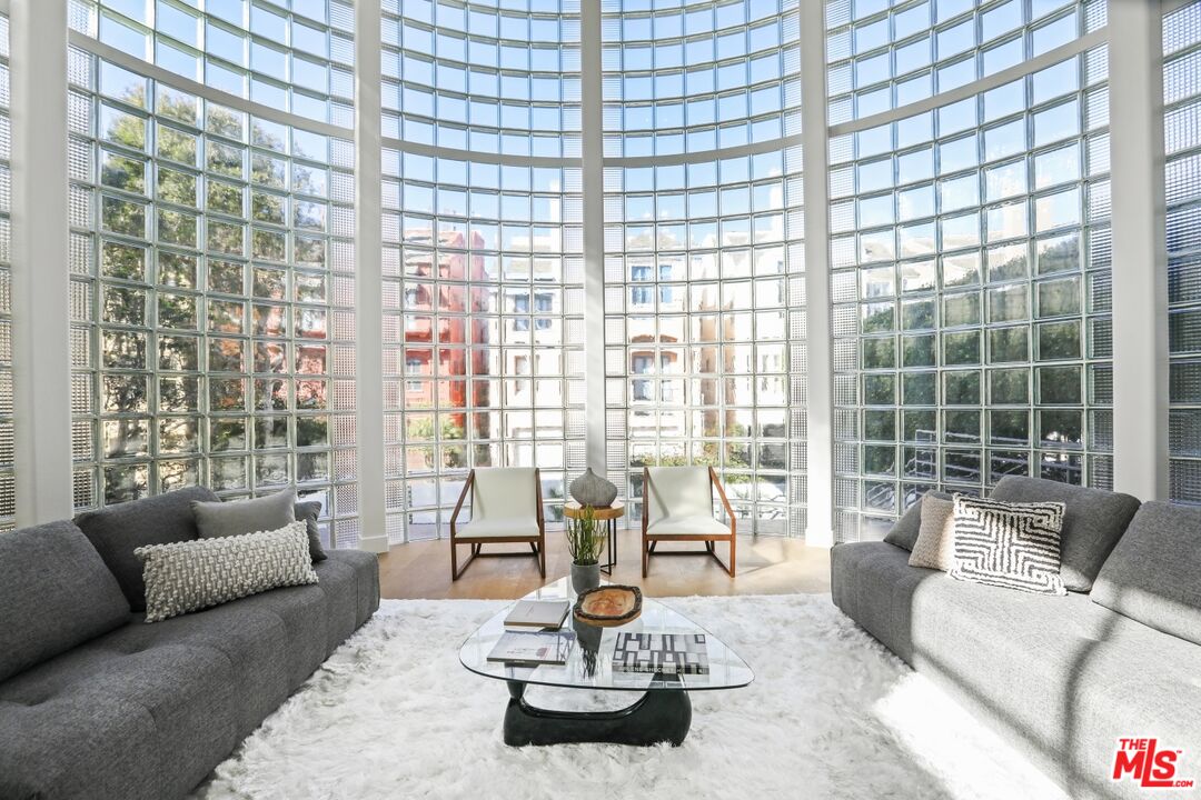 124 Roma Court Marina del Rey, CA 90292 - Photo 11 of 50 a living room with couch next to a large window with outer view