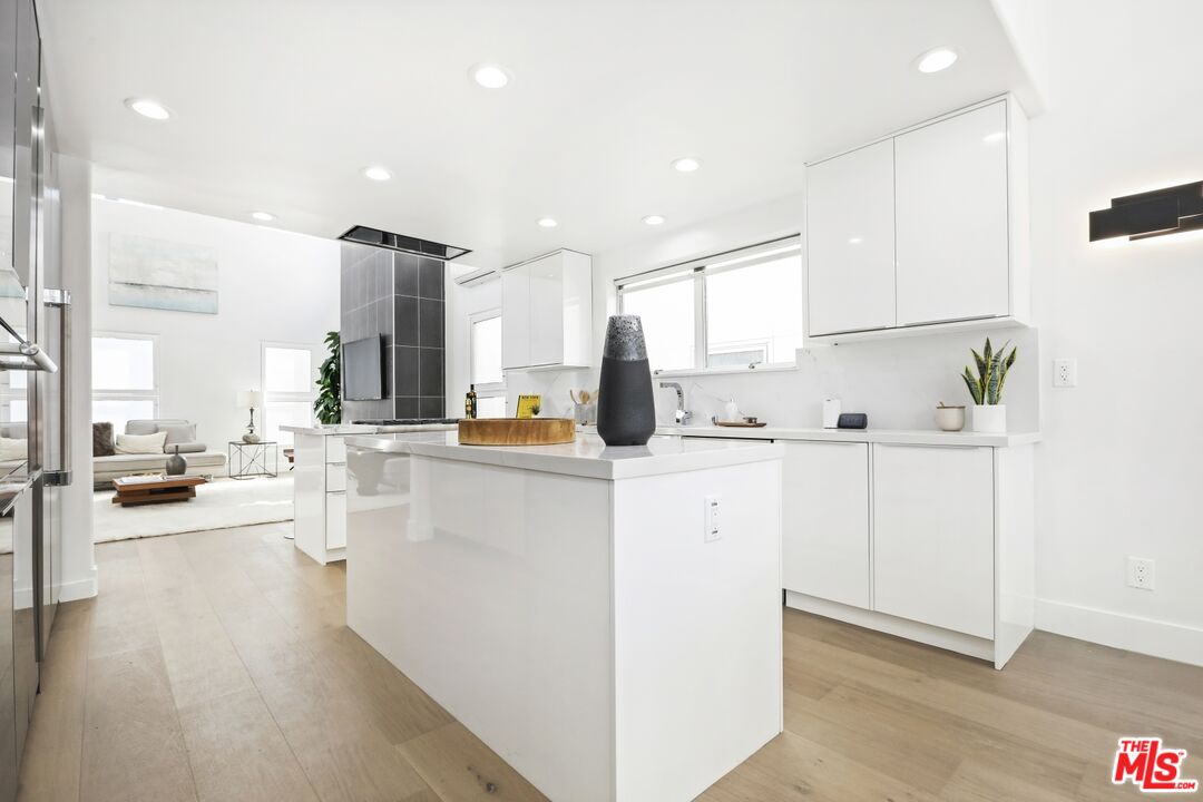 124 Roma Court Marina del Rey, CA 90292 - Photo 15 of 50 a kitchen with white cabinets and refrigerator
