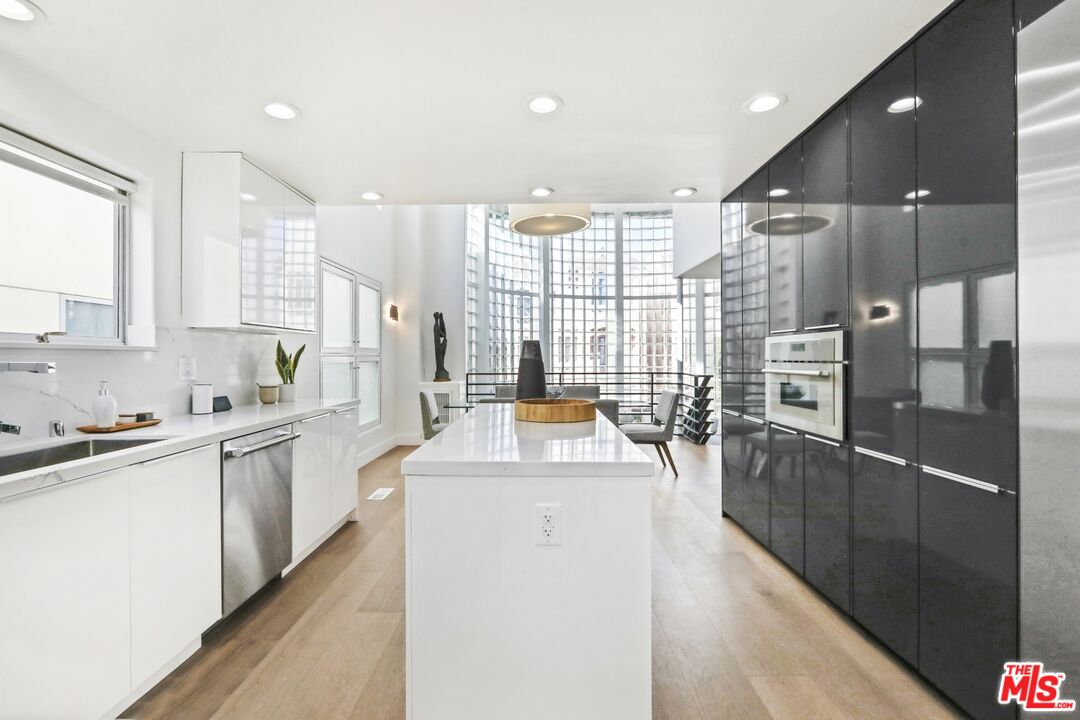 124 Roma Court Marina del Rey, CA 90292 - Photo 16 of 50 a kitchen with counter top space appliances and windows