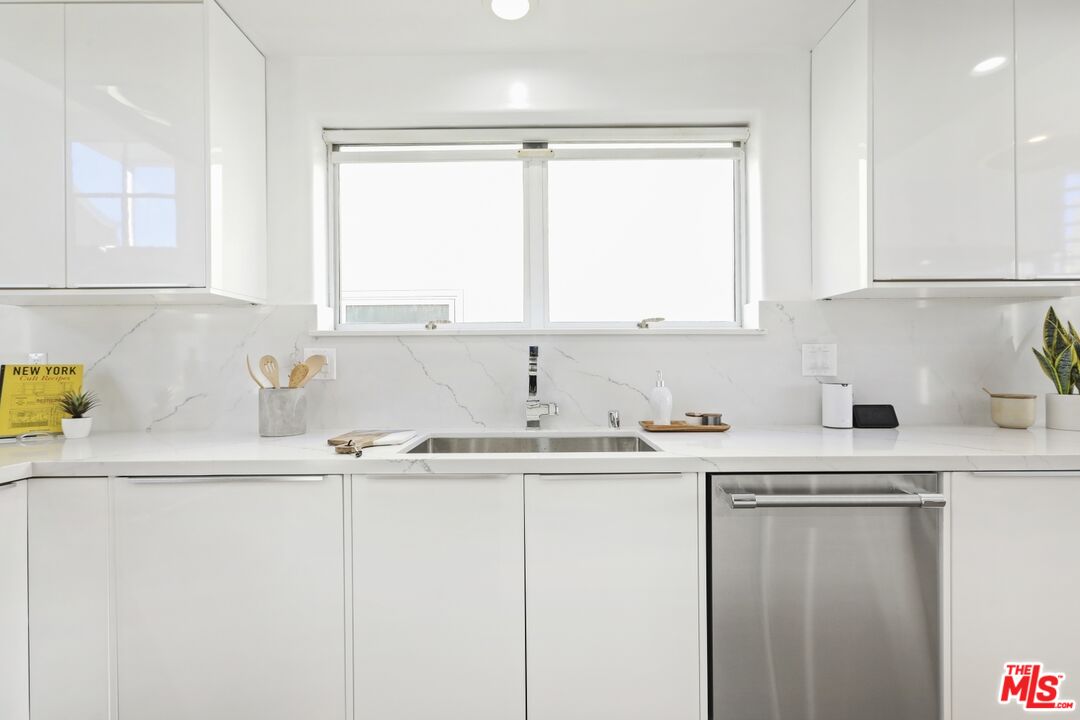 124 Roma Court Marina del Rey, CA 90292 - Photo 18 of 50 a kitchen with a sink a window and cabinets