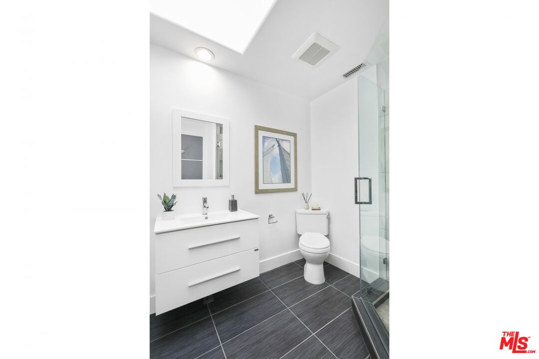 124 Roma Court Marina del Rey, CA 90292 - Photo 43 of 50 a bathroom with a toilet sink and a mirror
