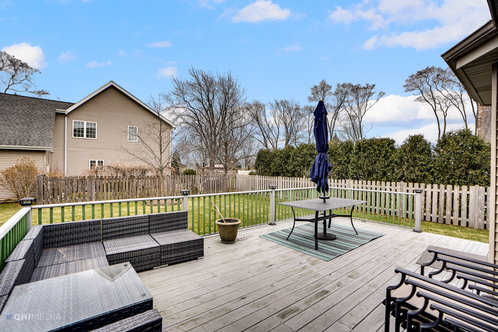511 Russell Street Wheeling, IL 60090 - Photo 19 of 20 a view of a deck with couches table and chairs with wooden floor and fence