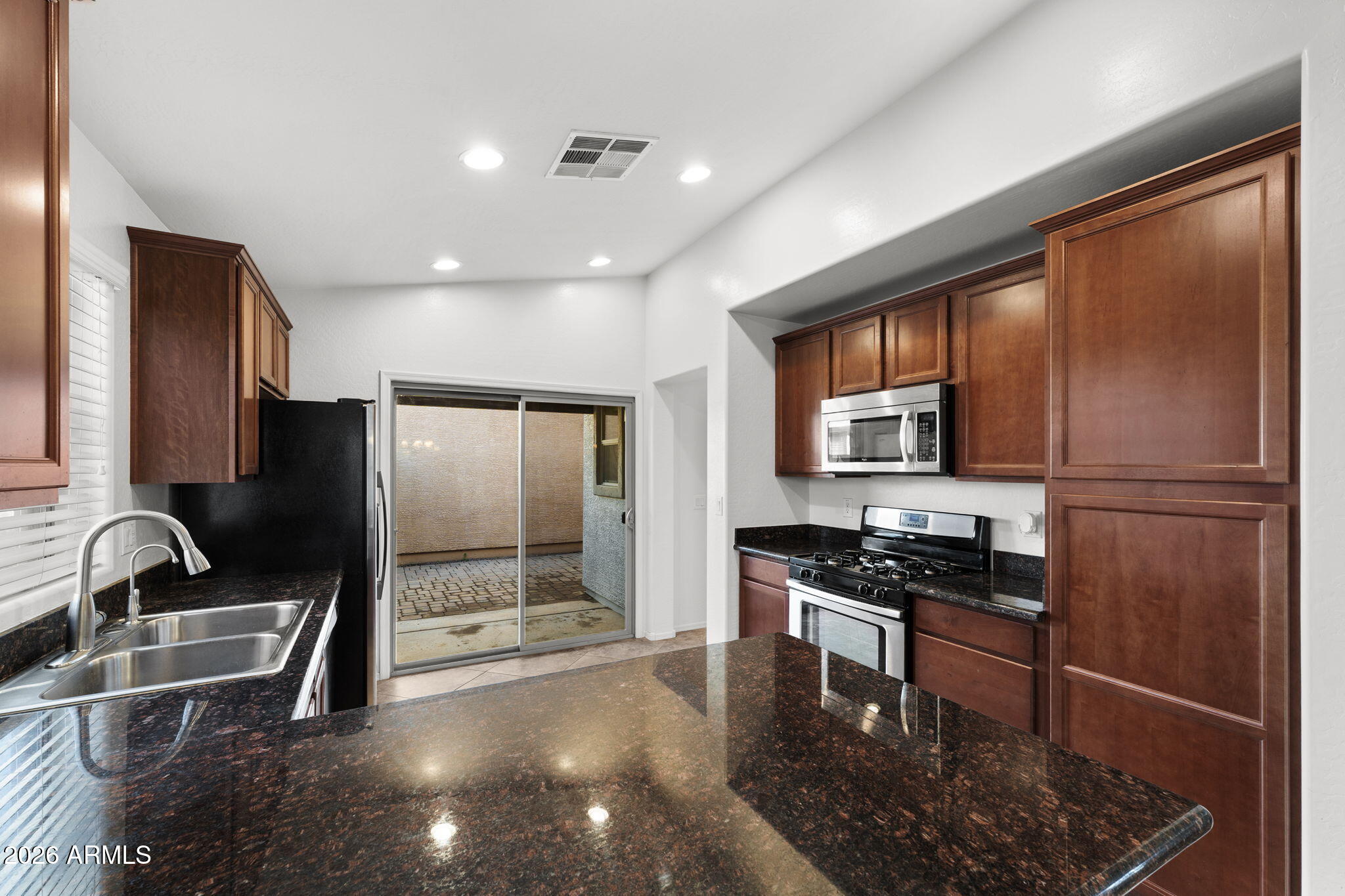 3500 East Milky Way Gilbert, AZ 85295 - Photo 8 of 23 a kitchen with stainless steel appliances granite countertop a refrigerator and a sink