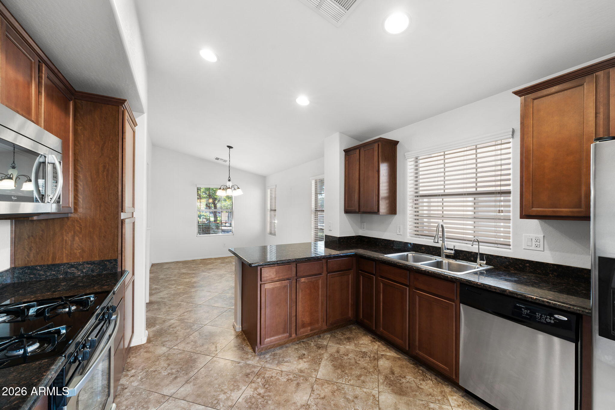 3500 East Milky Way Gilbert, AZ 85295 - Photo 9 of 23 a kitchen with a sink stove and cabinets