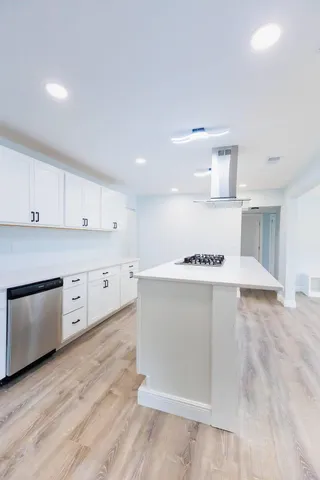 a view of kitchen with stainless steel appliances cabinets and wooden floor
