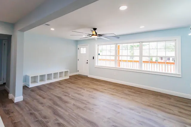 wooden floor in an empty room with a window